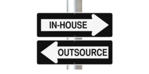 signposts saying in-house and outsource in opposite directions